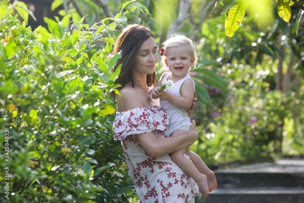 Portrait of happy mother with her baby girl in the park during a nice summer day Portrait of happy mother with her baby girl in the park during a nice summer day