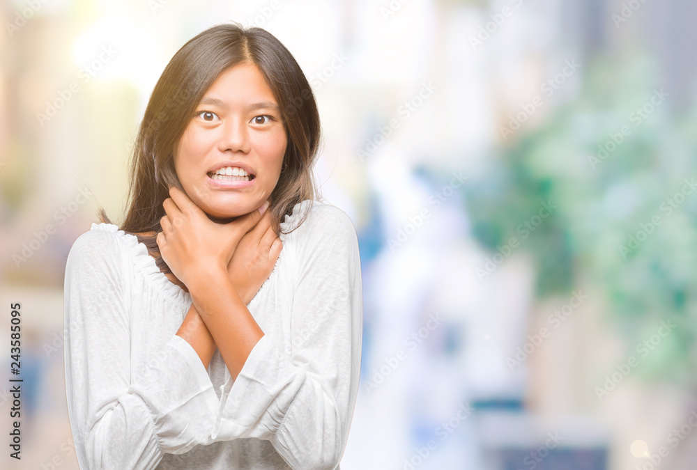 Young asian woman over isolated background shouting and suffocate because painful strangle. Health problem. Asphyxiate and suicide concept. Young asian woman over isolated background shouting and suffocate because painful strangle. Health problem. Asphyxiate and suicide concept.