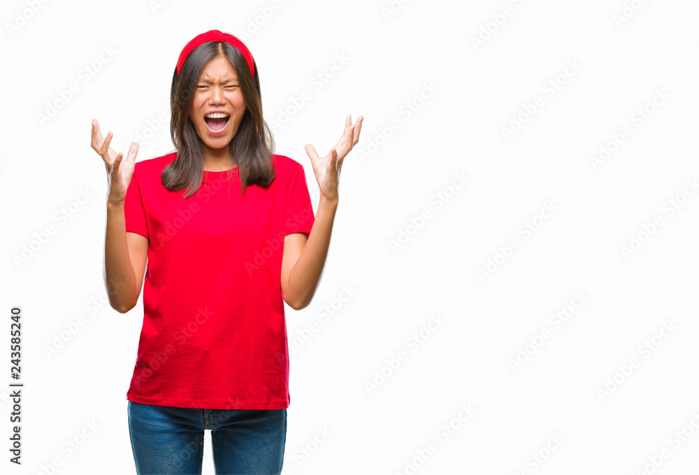 Young asian woman over isolated background crazy and mad shouting and yelling with aggressive expression and arms raised. Frustration concept. Young asian woman over isolated background crazy and mad shouting and yelling with aggressive expression and arms raised. Frustration concept.