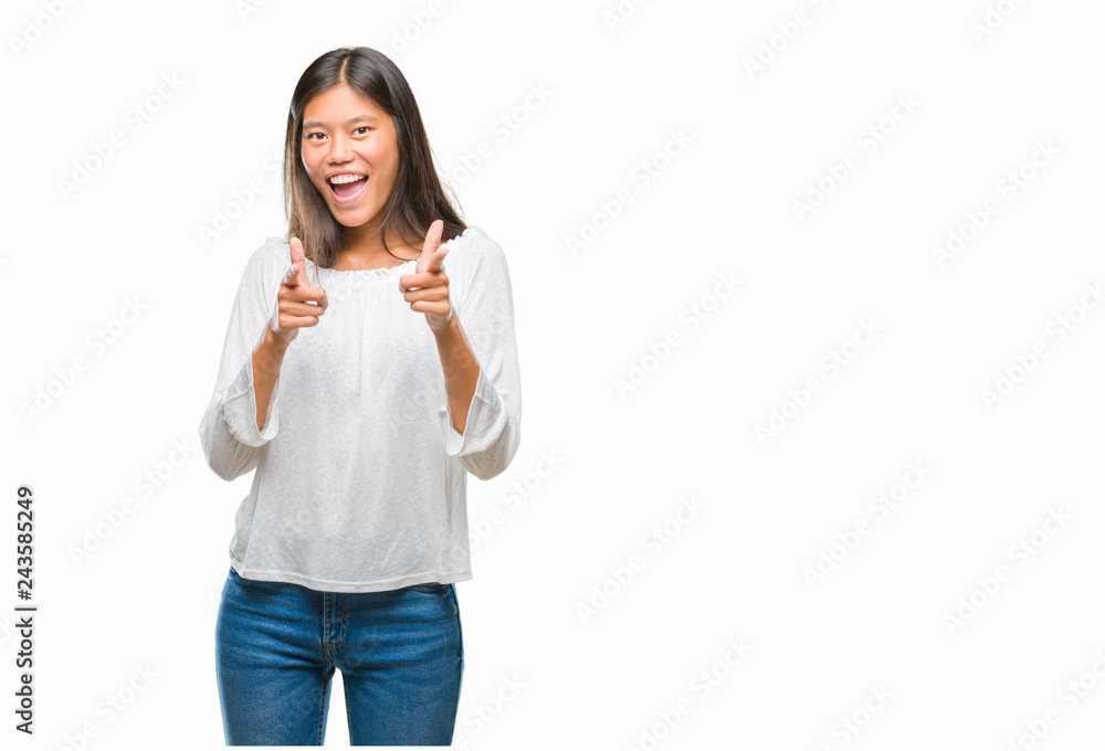 Young asian woman over isolated background pointing fingers to camera with happy and funny face. Good energy and vibes. Young asian woman over isolated background pointing fingers to camera with happy and funny face. Good energy and vibes.