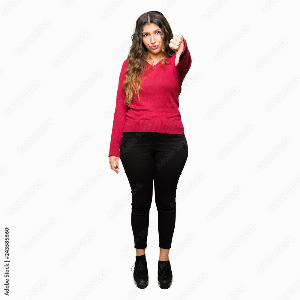 Young beautiful woman wearing red sweater looking unhappy and angry showing rejection and negative with thumbs down gesture. Bad expression. Young beautiful woman wearing red sweater looking unhappy and angry showing rejection and negative with thumbs down gesture. Bad expression.