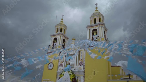 Slow Motion Church with dark thunderstorm clouds in background. WIth flags flapping in the wind and beautiful colors. Shot in 1080 120FPS photo