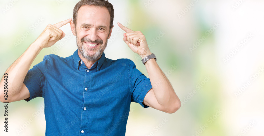 Handsome middle age elegant senior man over isolated background Smiling pointing to head with both hands finger, great idea or thought, good memory Handsome middle age elegant senior man over isolated background Smiling pointing to head with both hands finger, great idea or thought, good memory