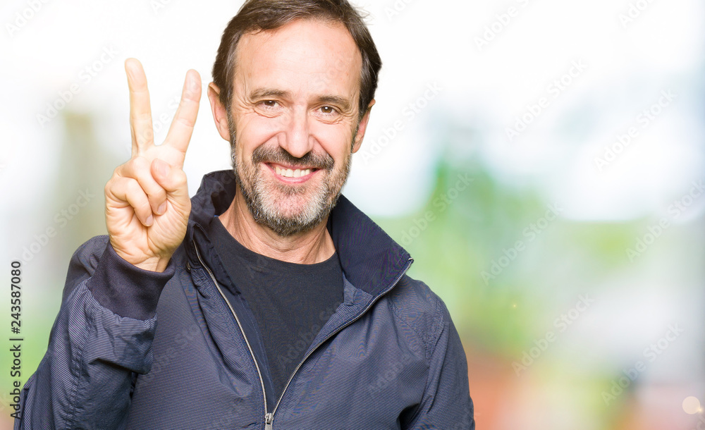Middle age handsome man wearing a jacket showing and pointing up with fingers number two while smiling confident and happy. Middle age handsome man wearing a jacket showing and pointing up with fingers number two while smiling confident and happy.