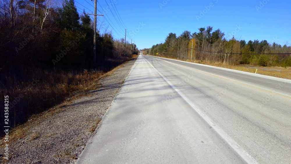 Viewpoint of Rural Road With Scarce Traffic in Daytime. Street View of Near Vacant Country Street in Day. Viewpoint of Rural Road With Scarce Traffic in Daytime. Street View of Near Vacant Country Street in Day.