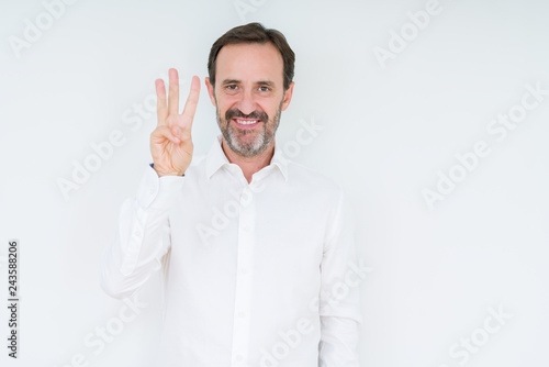 Elegant senior man over isolated background showing and pointing up with fingers number three while smiling confident and happy. © Krakenimages.com
