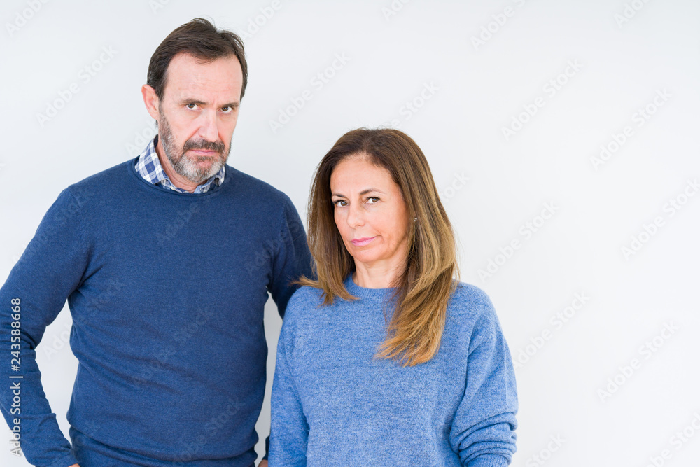Beautiful middle age couple in love over isolated background skeptic and nervous, frowning upset because of problem. Negative person. Beautiful middle age couple in love over isolated background skeptic and nervous, frowning upset because of problem. Negative person.