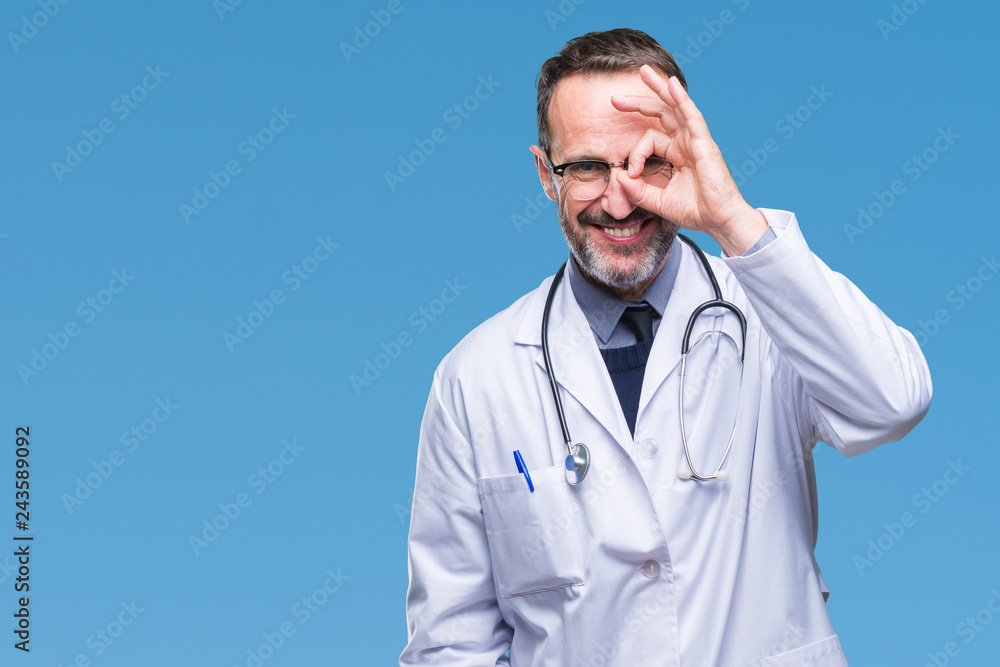 Middle age senior hoary doctor man wearing medical uniform isolated background doing ok gesture with hand smiling, eye looking through fingers with happy face. Middle age senior hoary doctor man wearing medical uniform isolated background doing ok gesture with hand smiling, eye looking through fingers with happy face.
