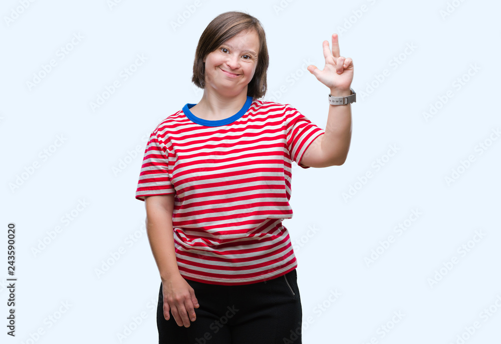 Young adult woman with down syndrome over isolated background showing and pointing up with fingers number three while smiling confident and happy.