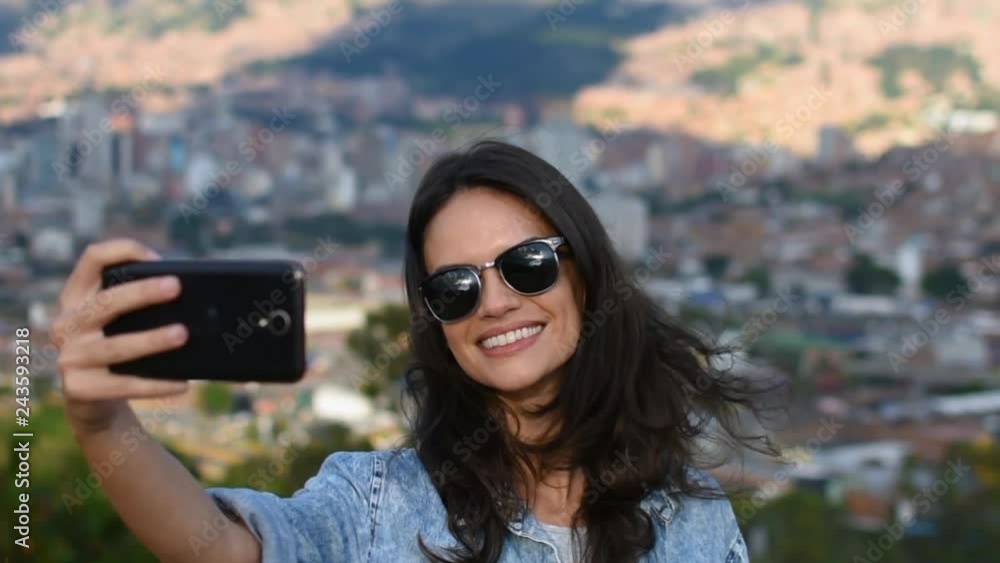 Slow motion close up of beautiful smiling girl with sunglasses taking selfie, Stunning young smiling woman posing for selfie in touristic landmark Slow motion close up of beautiful smiling girl with sunglasses taking selfie, Stunning young smiling woman posing for selfie in touristic landmark