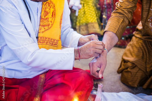 Indian pre wedding ceremony haldi red thread