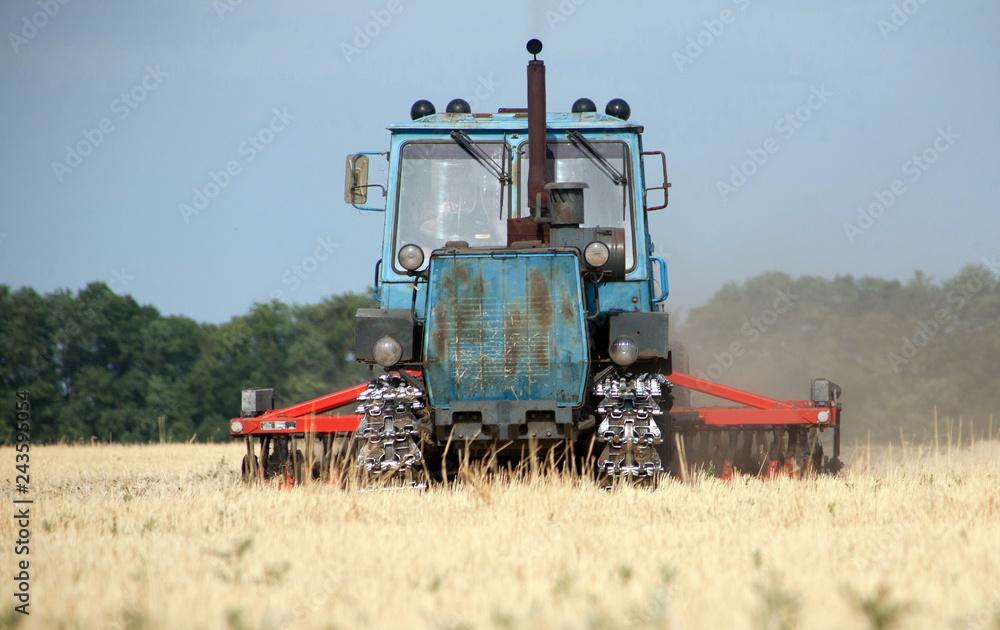 Fototapeta premium Tractor preparing land for sowing