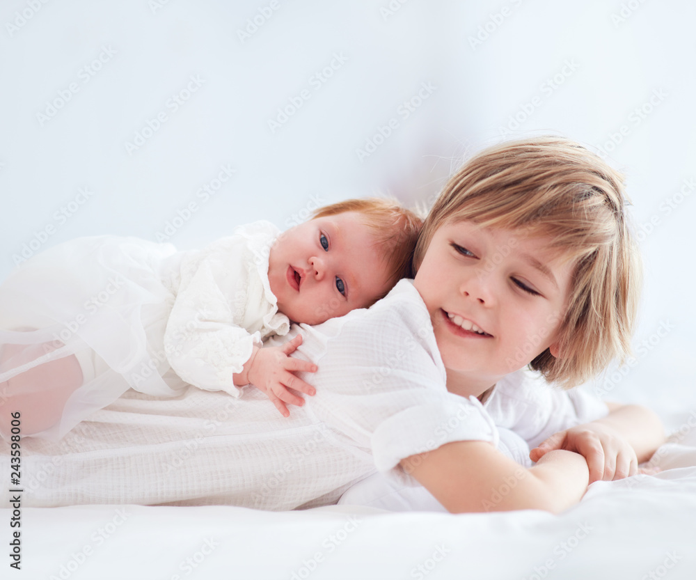 newborn baby sister lying on cute elder brother newborn baby sister lying on cute elder brother