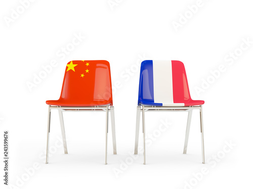 Two chairs with flags of China and france isolated on white