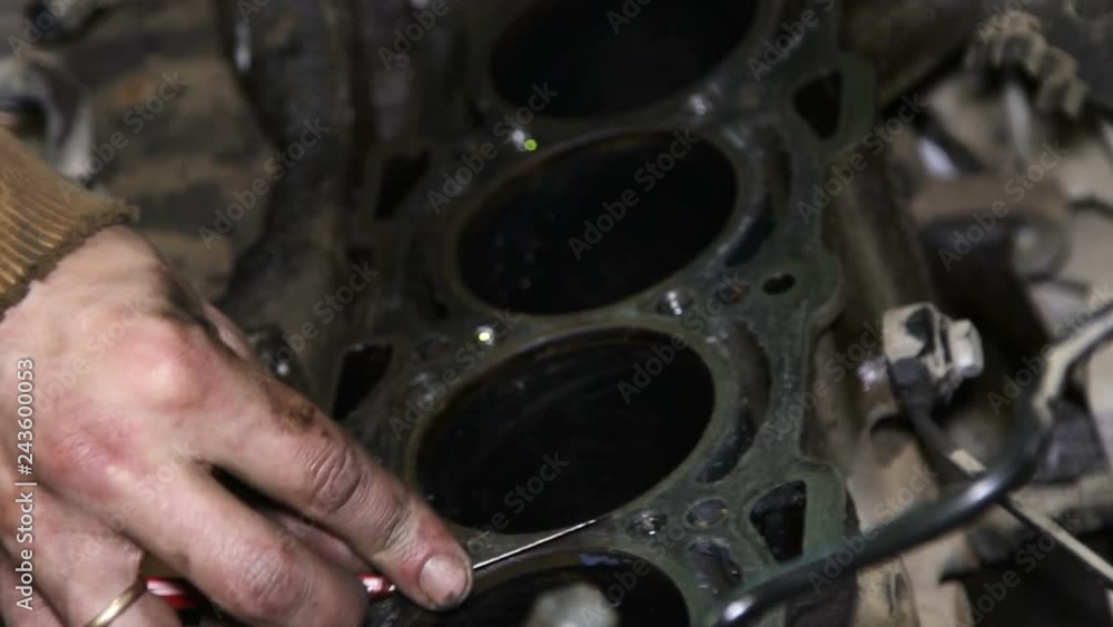 Mechanic repairs the car engine Mechanic repairs the car engine