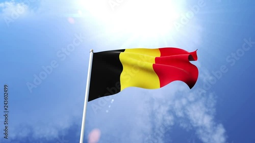 The national flag of the kingdom of Belgium waving in the wind on a sunny day.  Beautiful slow motion shot of the Belgian flag. photo