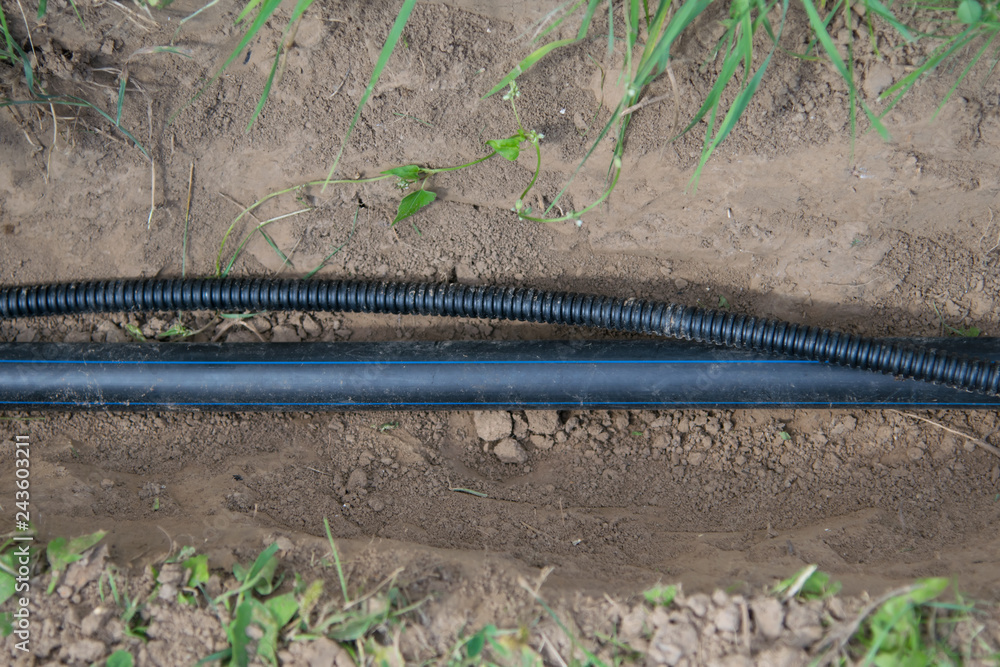 laying of communications, supply of water and electricity to buildings under the ground, an uncovered trench and a pipe connection section laying of communications, supply of water and electricity to buildings under the ground, an uncovered trench and a pipe connection section