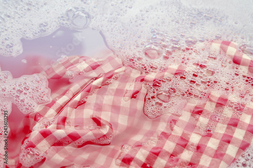 Soak  red white tablecloth before washing