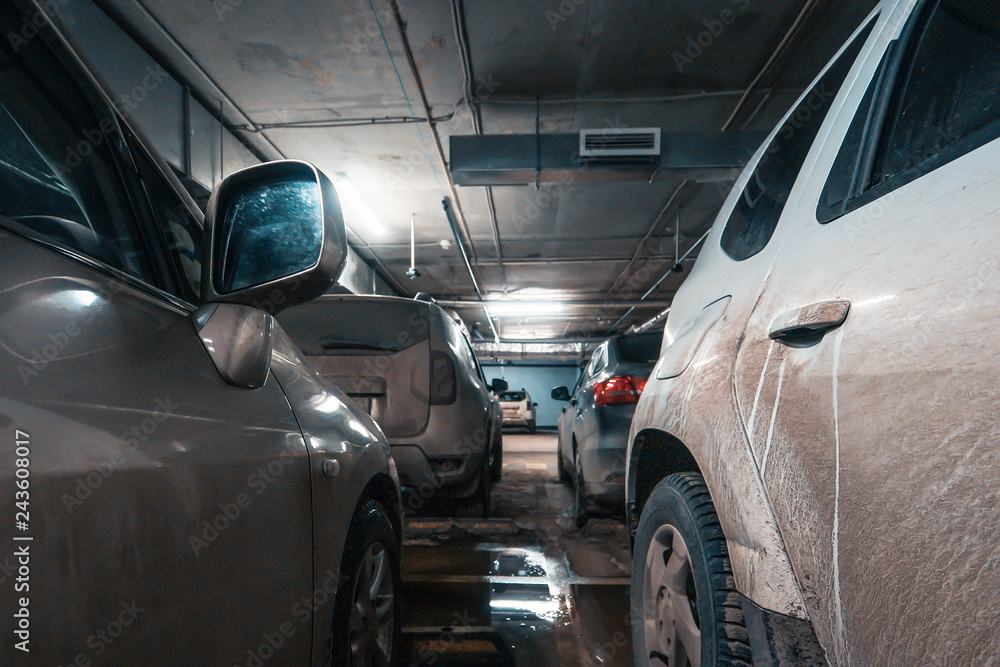 Cars in underground illuminated car parking Cars in underground illuminated car parking