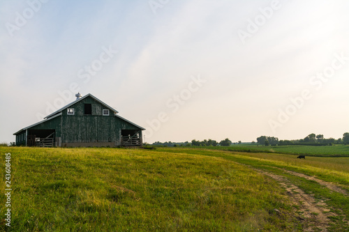 Rural farm pasture with old barn on a Summer's morning. Millbrook, Illinois, USA