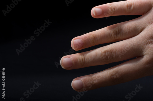 Four fingers of a human hand partly seen in view photo