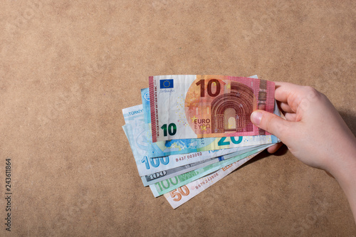 Hand holding American dollar  isolated on wooden background photo