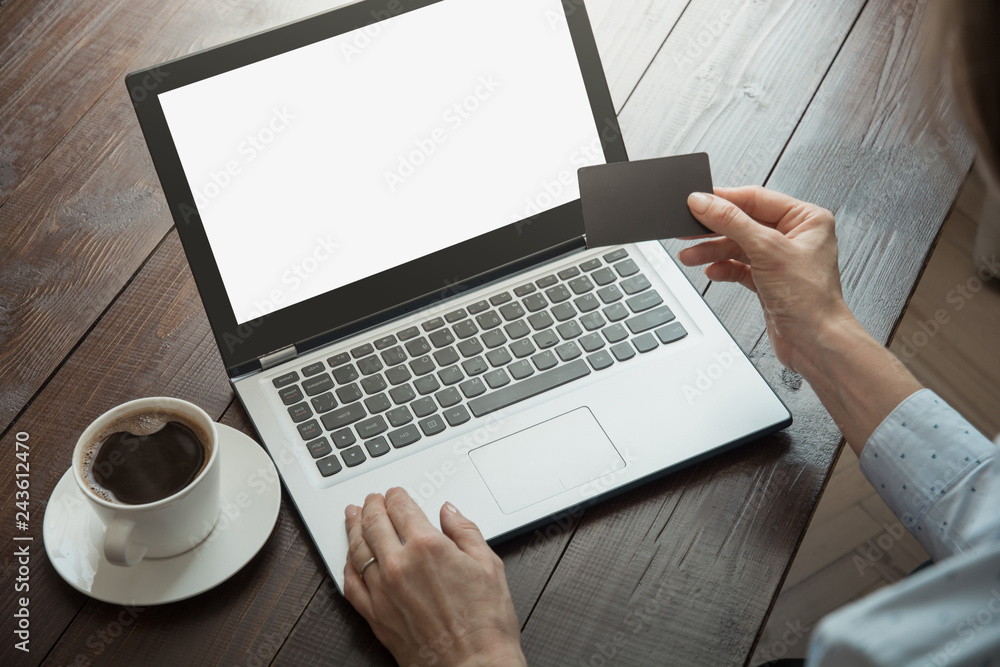 Woman shopping or booking with credit card by laptop. Space in screen for text. Woman shopping or booking with credit card by laptop. Space in screen for text.