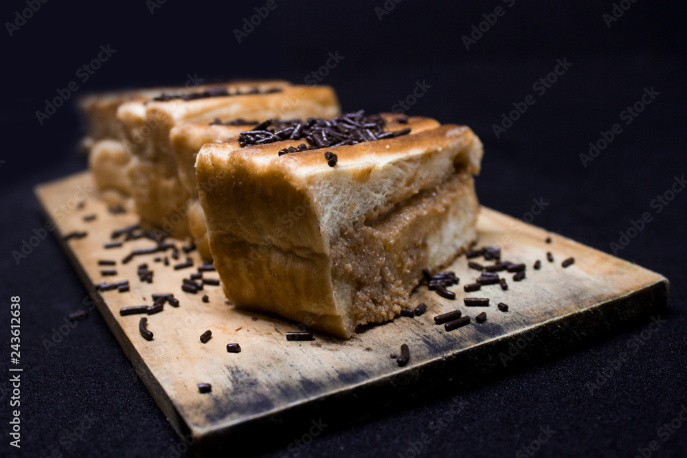toast with chocolate sprinkles and tea to accompany relaxing time with a black background toast with chocolate sprinkles and tea to accompany relaxing time with a black background