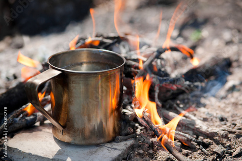 Camping cooking on a campfire outdoor, tourist kettle