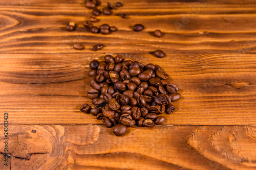 Pile of the coffee beans on wooden table