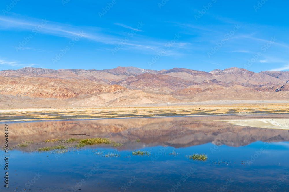 Mountains reflected in a rehydrated section of Owens Lake in California, USA