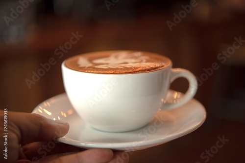 hand holding a cup of coffee