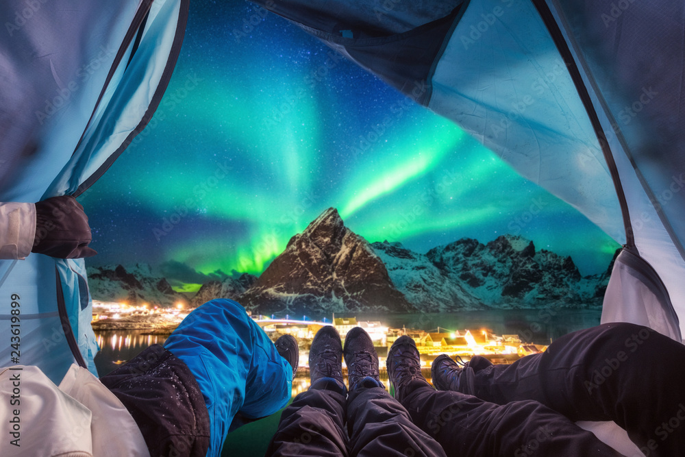 Group of climber are inside camping with aurora borealis over mountain - obrazy, fototapety, plakaty 