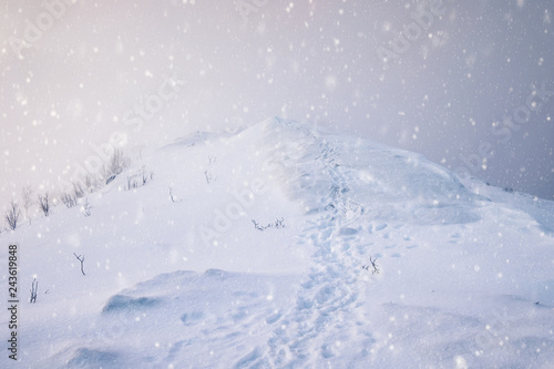 Snowy mountain peak with footprints