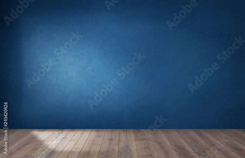 Dark blue wall in an empty room with a wooden floor photo