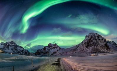 Northern lights explosion on snowy mountain range