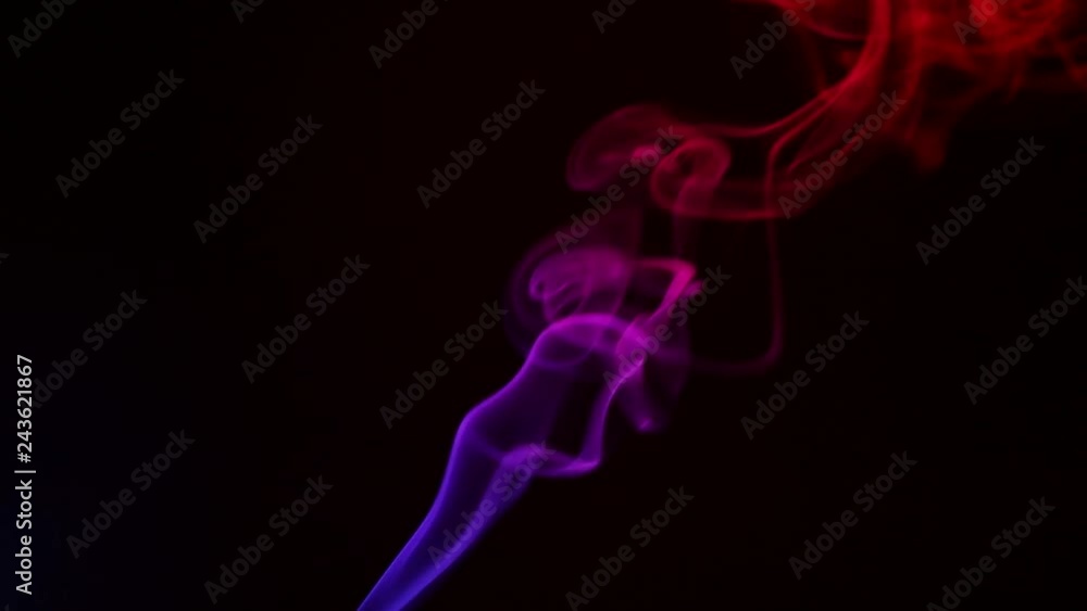 Multicolored smoke from aromatic sticks close up on black background Multicolored smoke from aromatic sticks close up on black background