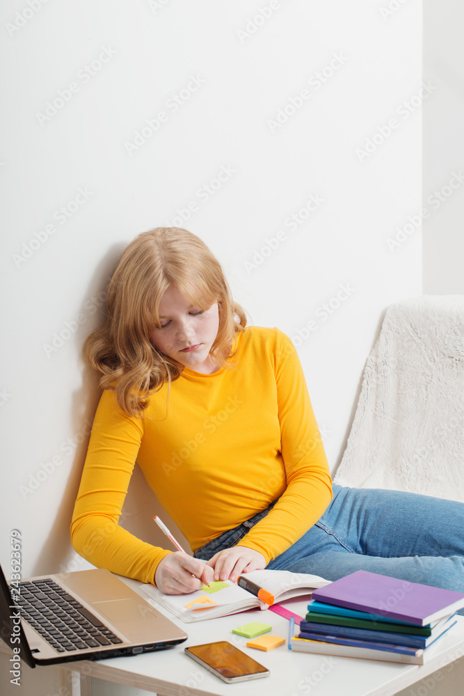 Teen girl studying and learning with notebook at home. Online education,e-learning. Teen girl studying and learning with notebook at home. Online education,e-learning.