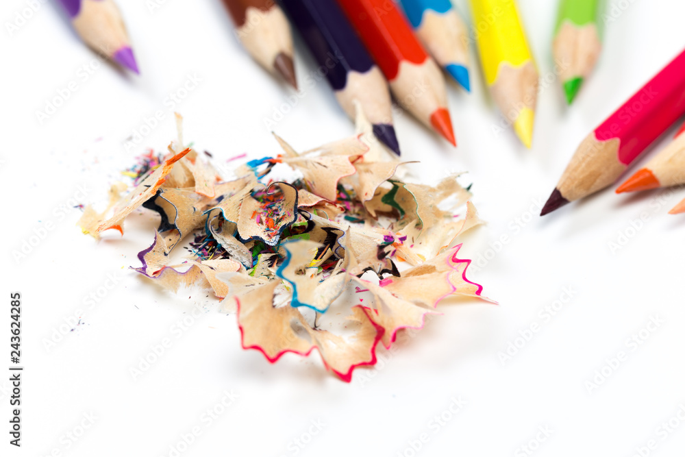 colored pencils and shavings with pencils. Sharpener of pencils on a white background. colored pencils and shavings with pencils. Sharpener of pencils on a white background.