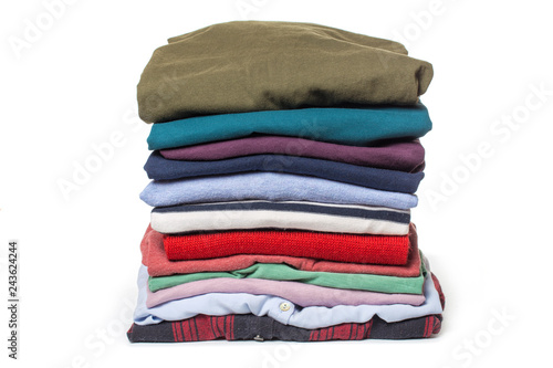 Stacks of folded clothes on white background.