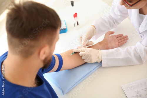 Female doctor drawing a blo...