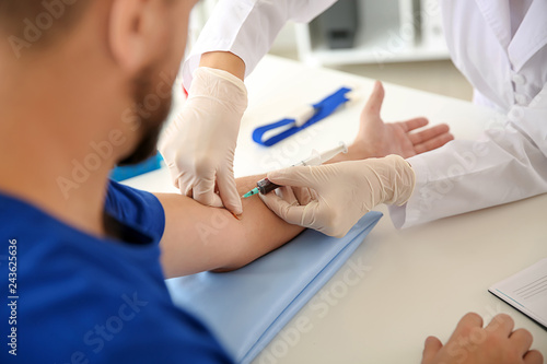 Female doctor drawing a blo...