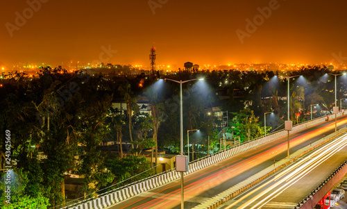 Night highway with car traffic  lights trails and city lights when long exposure  soft focus