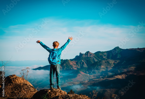happy young boy enjoy travel hiking in mountains
