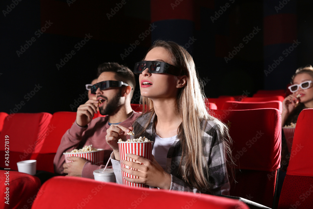 Young couple watching movie in cinema Young couple watching movie in cinema