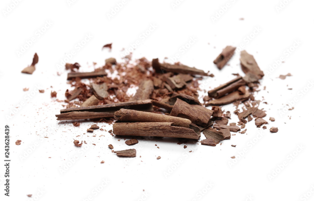 Fototapeta premium Cinnamon sticks with powder and shavings, macro isolated on white background