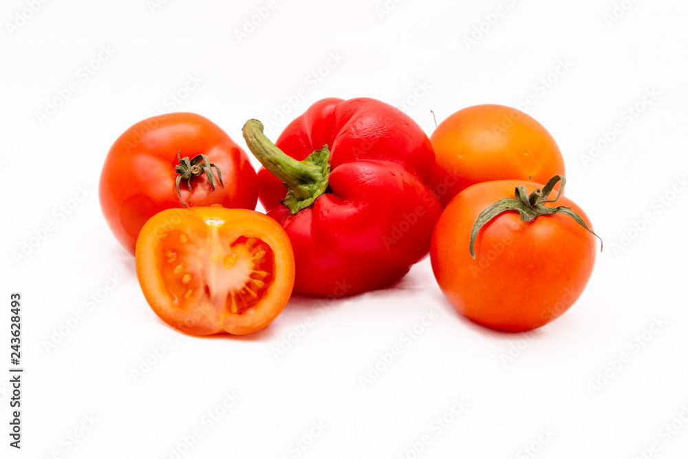 Juicy vegetables. Pepper Bulgarian and tomatoes. Isolated on white background Juicy vegetables. Pepper Bulgarian and tomatoes. Isolated on white background