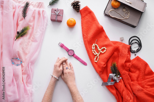 Hands of young woman, stylish bijouterie and accessories on white background