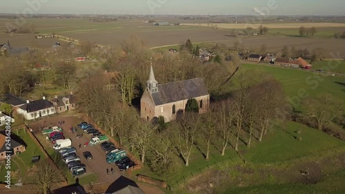 Aerial drone shot from the Andreas Church located on a mound in the center of Westeremden, The Netherlands. photo