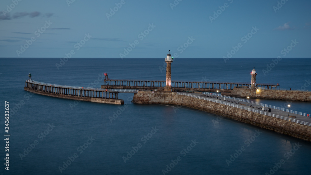 Evening light over the Whitby harbour and pier in North Yorkshire, England, UK - seen from the East Terrace